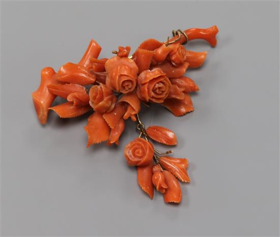 A carved coral floral spray drop brooch, width 68mm.